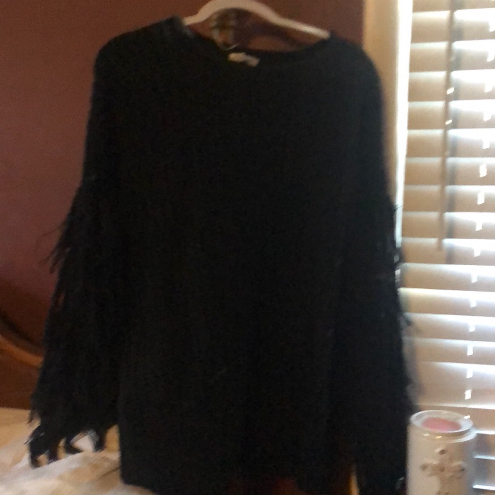 Black sweater with fringe on the arm